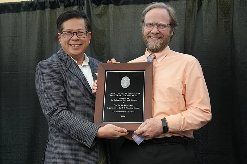 Colin Sumrall is presented an award by Liem Tran at the Faculty Awards Ceremony