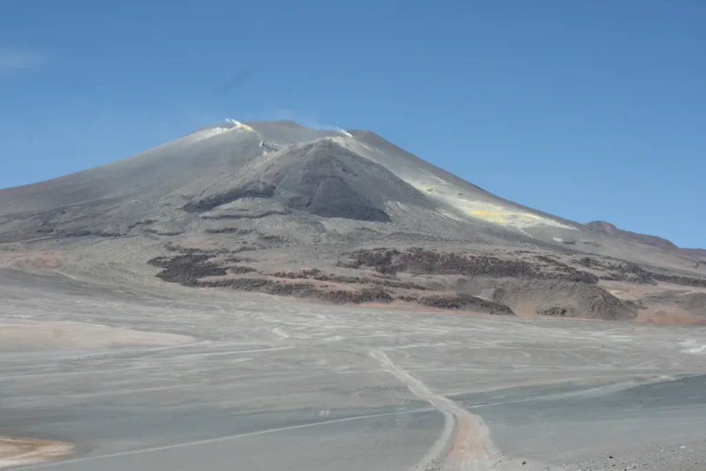 Photo of gray mountains set against a blue sky