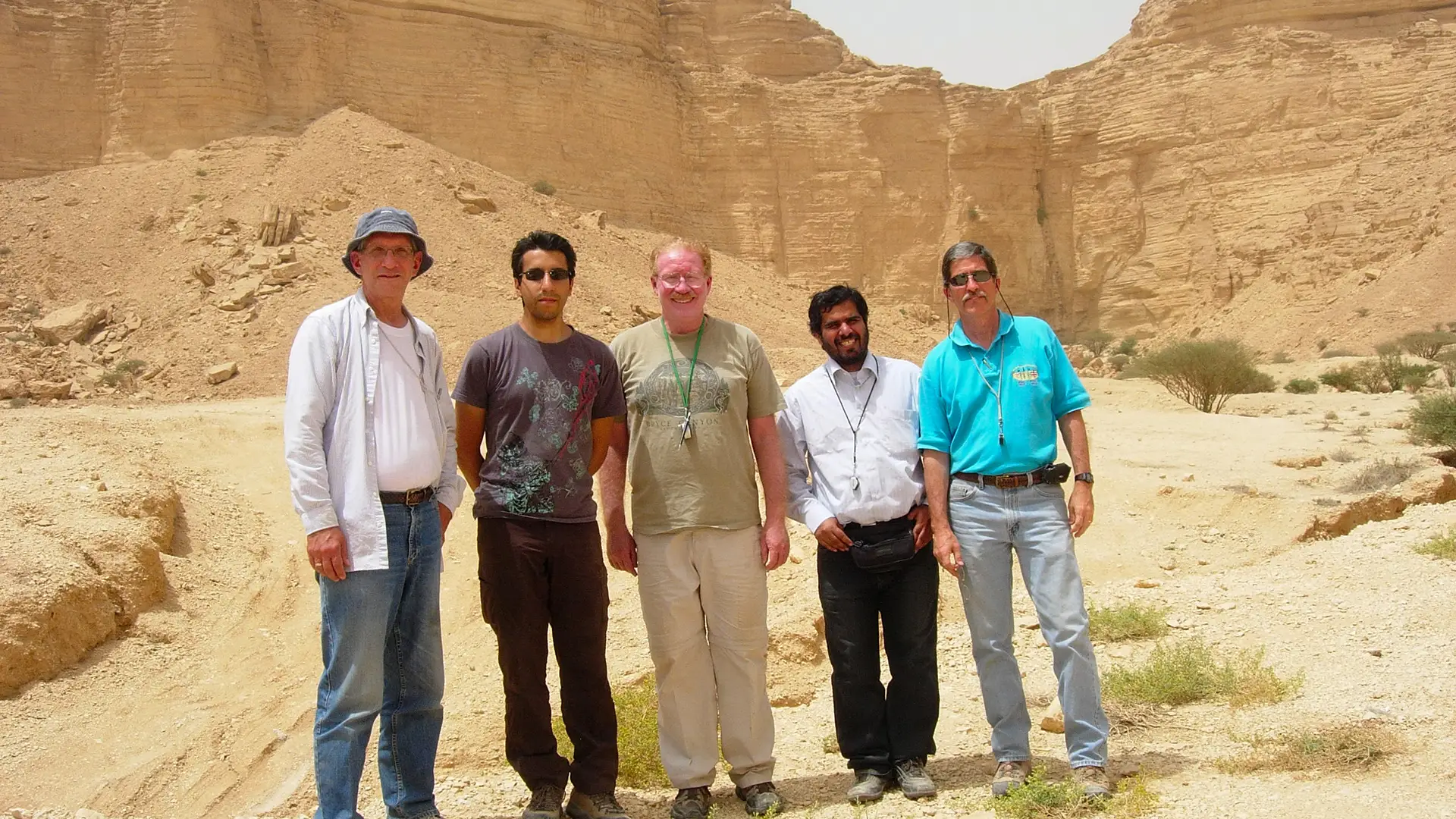 Group photo of five men in front of caverns