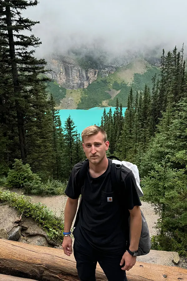 Tyler Seyglinksi standing by Lake Louise